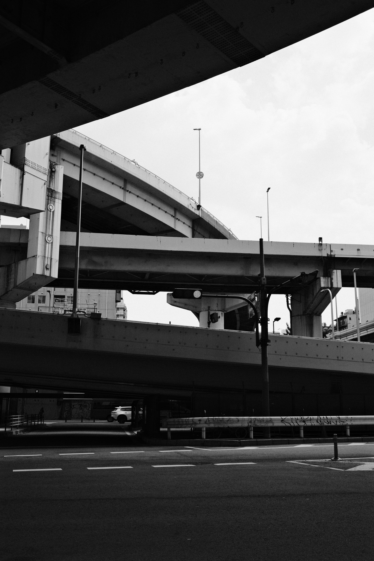 Layered concrete expressway overpasses under a flat sky
